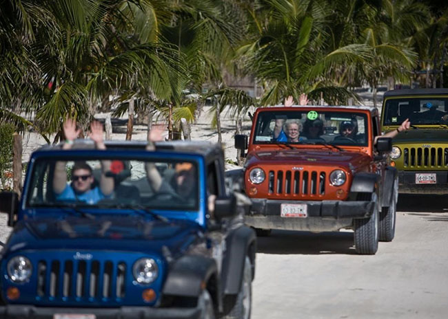 Jeffery and friends riding several Jeeps in the beach of Cozumel.
