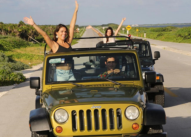 Alan, Martha, and Wanda riding a Jeep while seeing the Caribbean wonders.